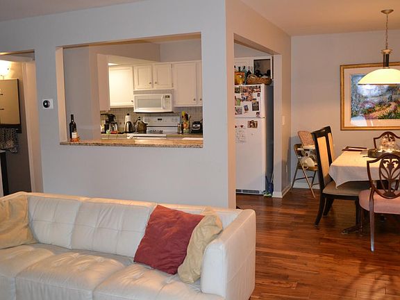 Main floor living room opens to dining space and kitchen wit