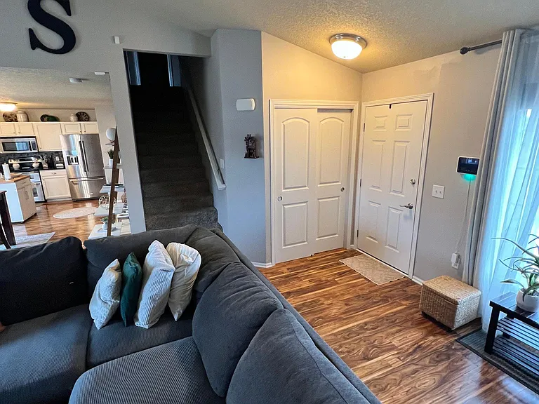 Living Room Looking to Entry, Closet and Stairs