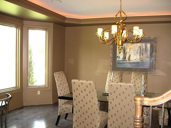Formal Dining room  w/hdw flrs, a large bay window & decorator lighting.