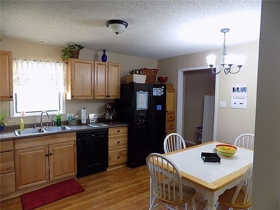 Spacious kitchen with update appliances and laminate wood floors.