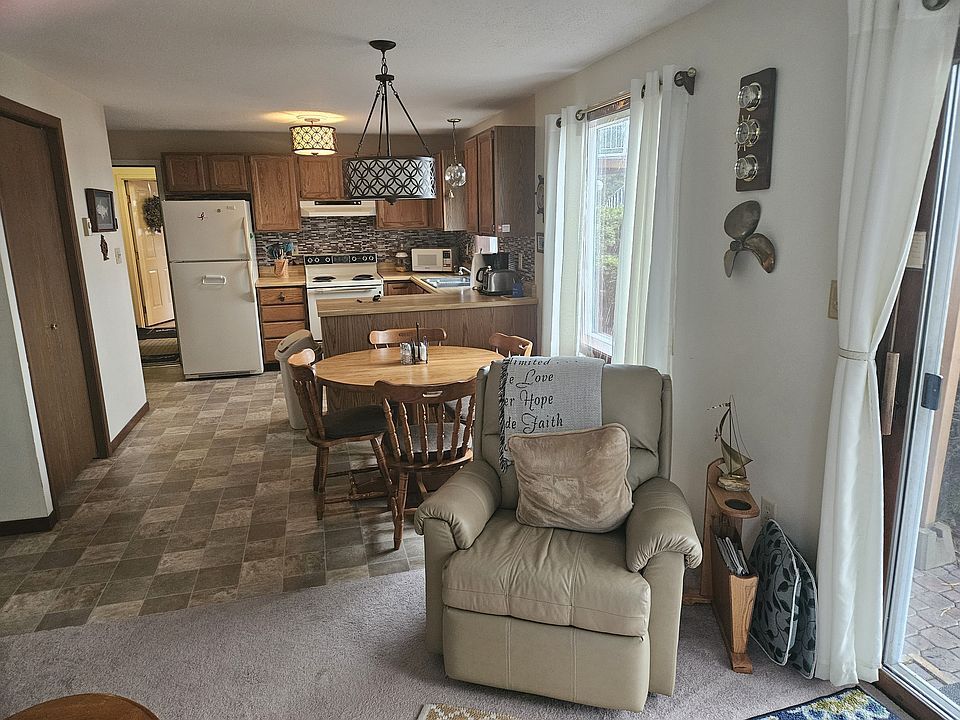 Living room, dining room and kitchen face River.