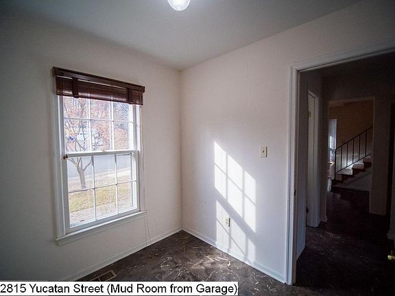 Mud room or small office looking to street