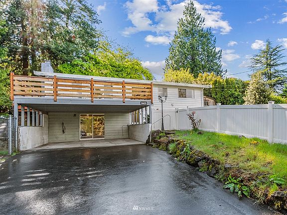 Oversized 2-car carport & huge entertainment style deck out front.