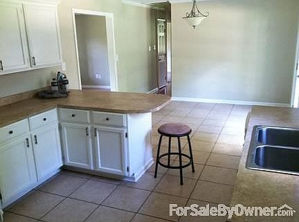 Kitchen, looking into Dining area
						:
						khaki color walls (color on ad not real)
