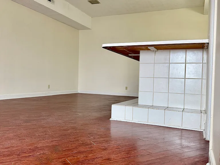 kitchen island/bar-top taken from entry/foryer. super high ceilings.