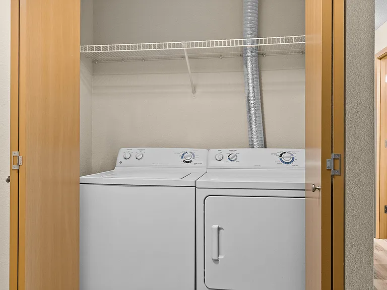 Convenient in-unit laundry with washer and dryer, tucked neatly behind closet doors. Convenient in-unit laundry with washer and dryer, tucked neatly behind closet doors.