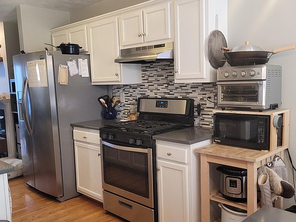 NIceley updated kitchen with stainless appliances and white cabinetry.