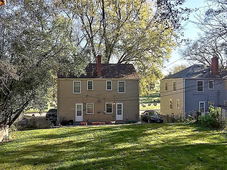 View from the deep, fenced back yard. Unit in on the left (north) side