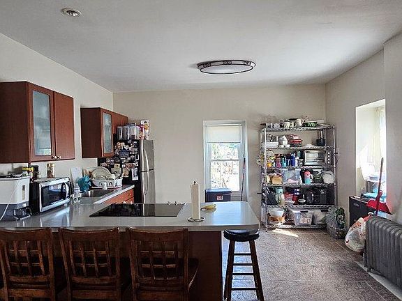Open kitchen countertop chairs and appliances