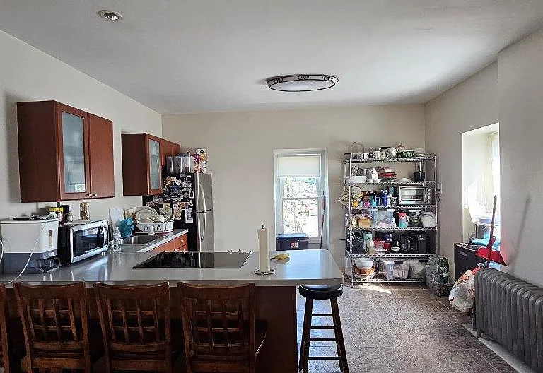 Open kitchen countertop chairs and appliances