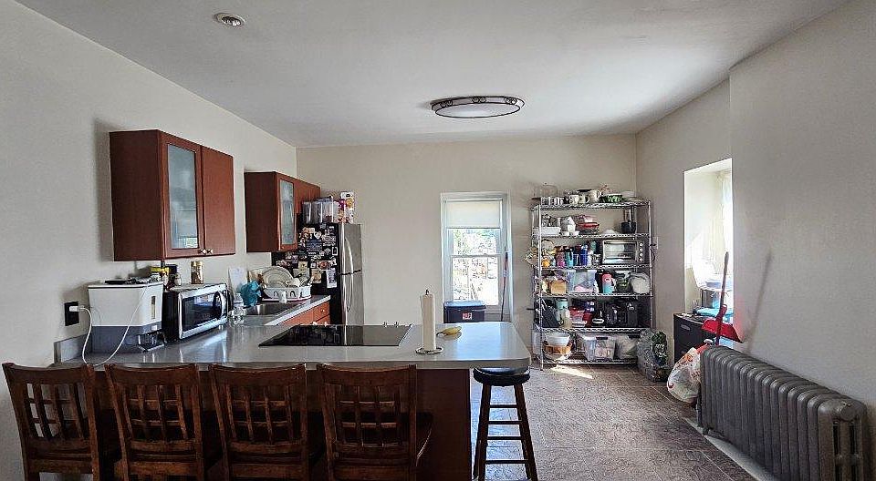 Open kitchen countertop chairs and appliances