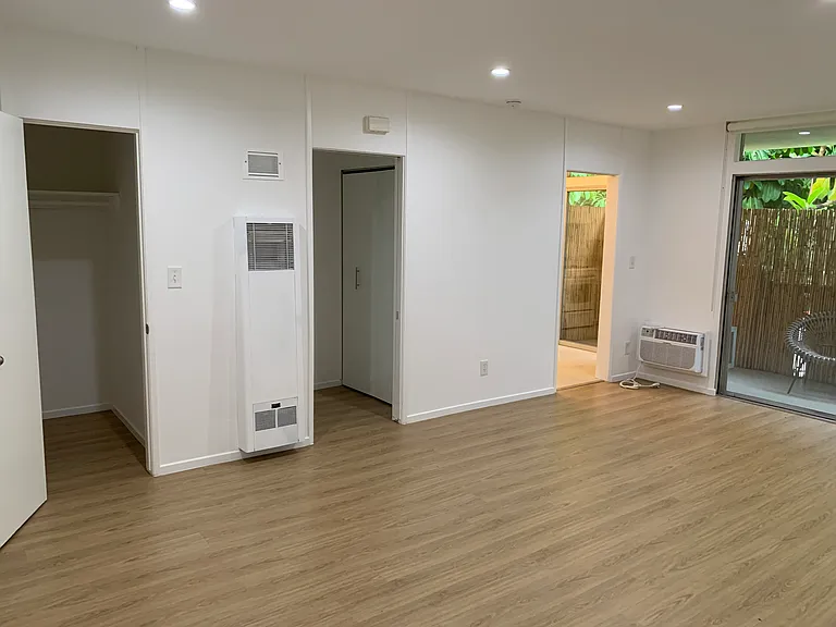 Main Room facing walk in closet, hallway and kitchen