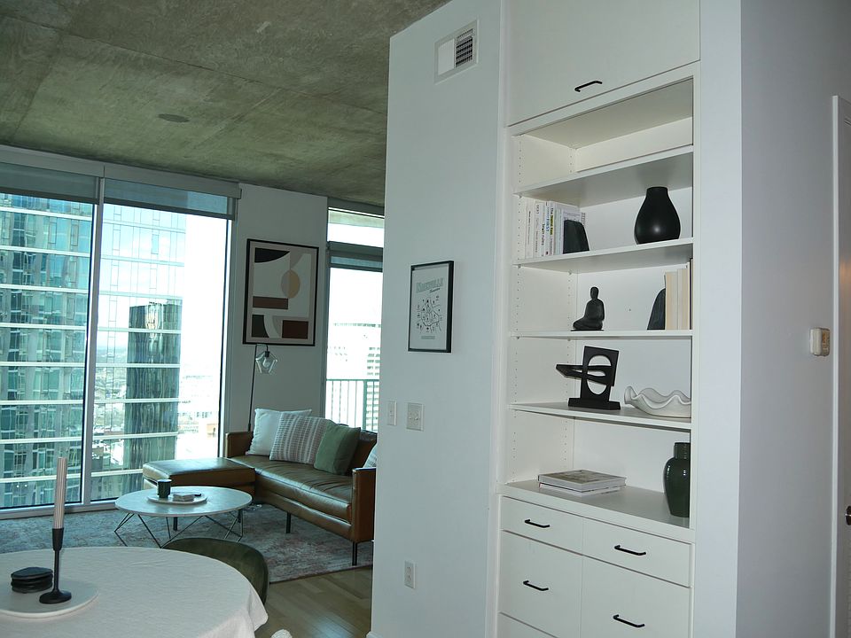 Built in bookshelf with file cabinets and a large storage area above