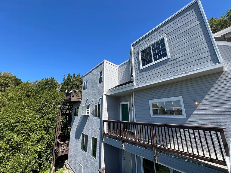 Expansive 3 story hillside and corner unit