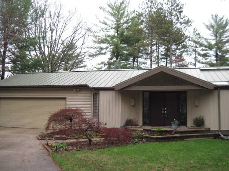 Love the metal roof and the pleasing elegance of the entry.