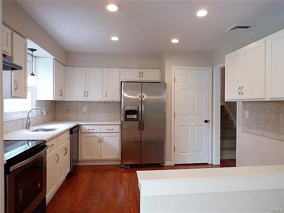 Remodeled kitchen with quartz countertops and new appliances