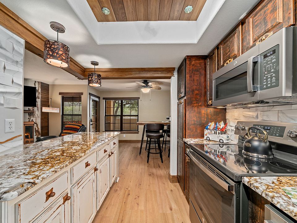 Expansive entertaining granite island. Laminate flooring throughout, easy to clean. Solid surface cooktop.