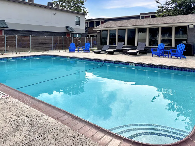 Relax and unwind at the sparkling swimming pool surrounded by lounge seating.