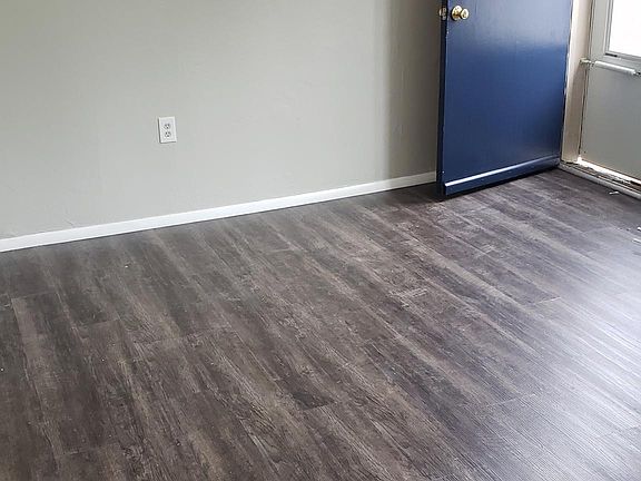 Brand new vinyl plank flooring looks great with new repose gray paint. Living room is 15x11.