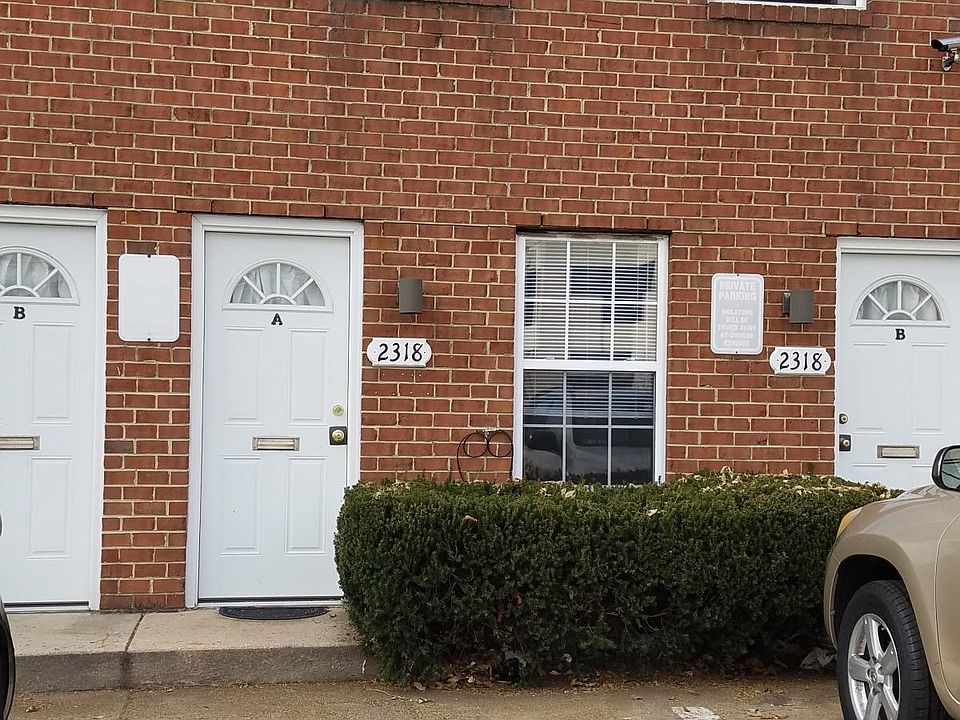 Front door with driveway in front. Parking for one car