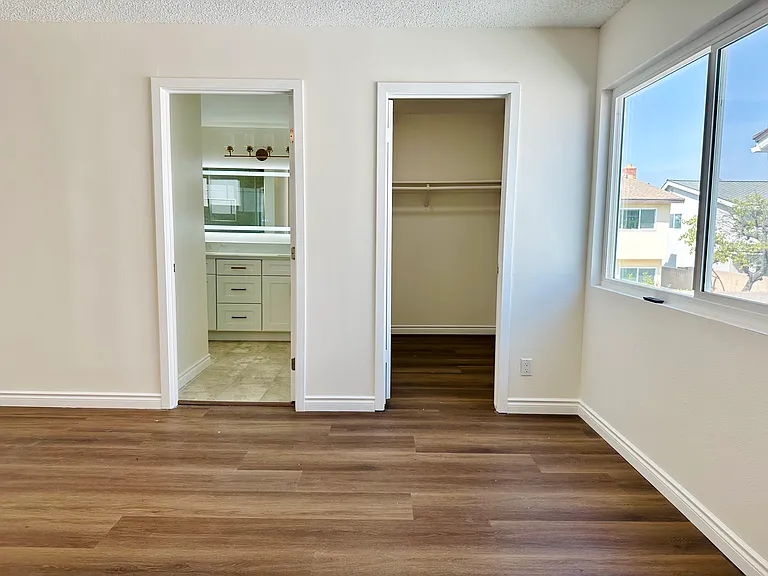 Primary master bedroom on second floor with walk-in closet and private bathroom
