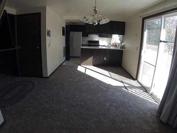 Dining room to kitchen view. Photo makes it look smaller than it is. Sliding glass doors lead outside.