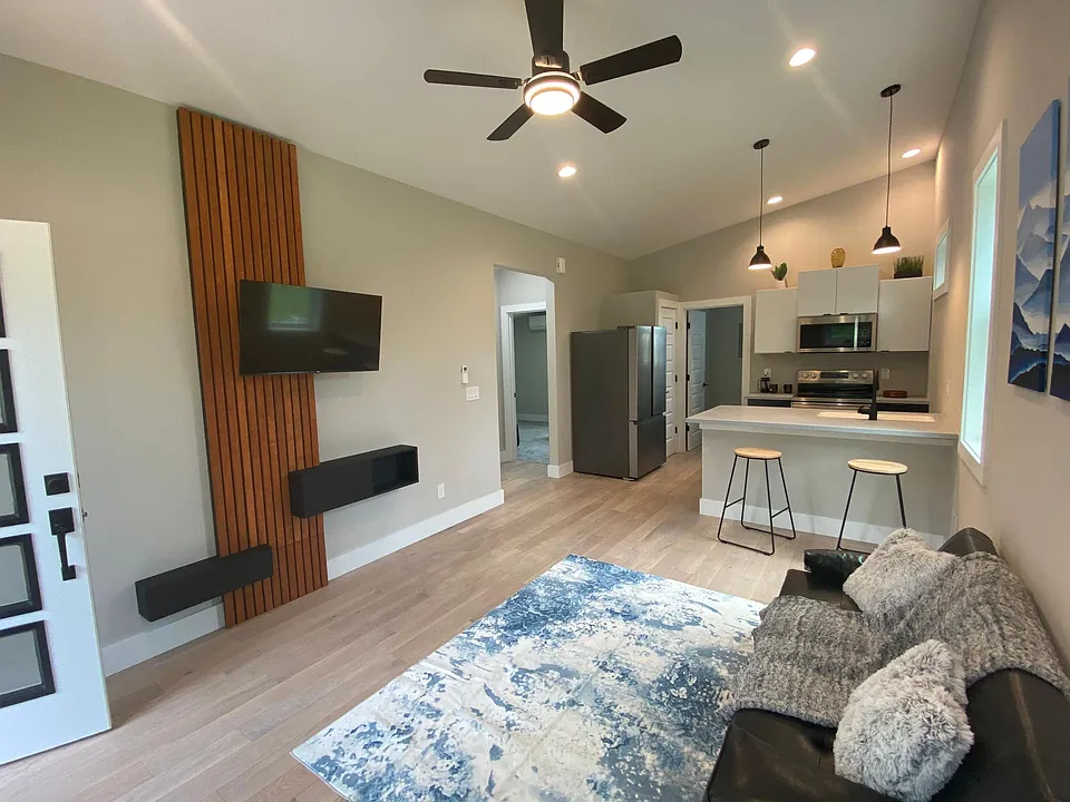 Living Room with Vaulted Ceiling, Decorative TV Wall, Modern Fixtures,