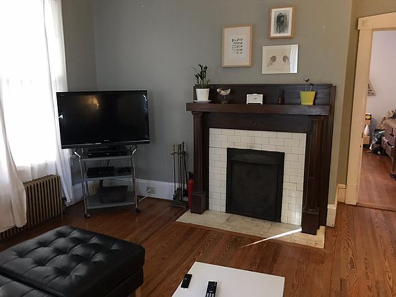 Living Room small log fireplace, door to MBR on right