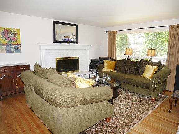 LOVELY FIREPLACE THAT ACCENTUATES THIS WELCOMING LIVING ROOM.