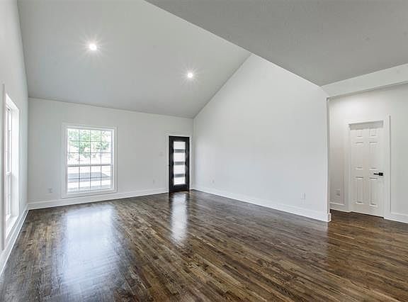 Large open living space features vaulted ceiling and plenty of natural light