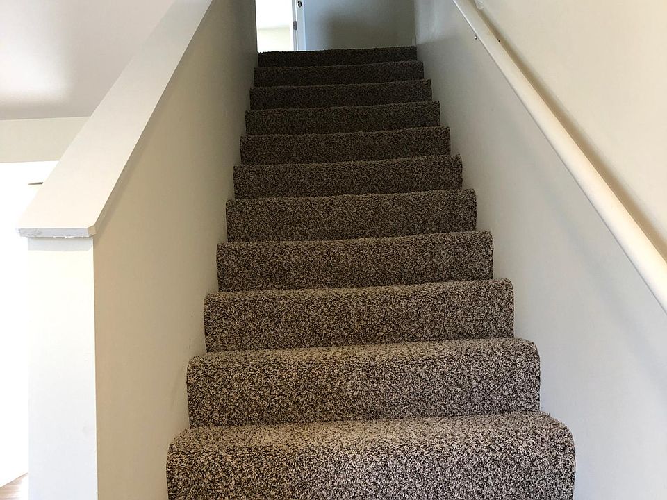 stairs going up to linen closet and two full bathrooms and two bedrooms with nice size closets windows have wood blinds,
