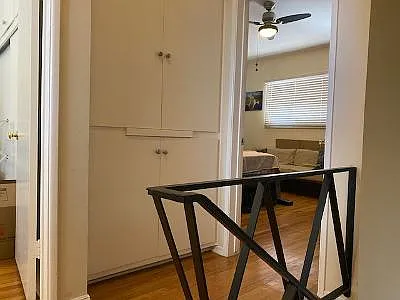 Hallway with linen closet leading to bedroom 2