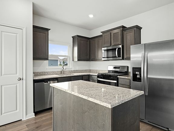 The kitchen has sprawling granite countertops.