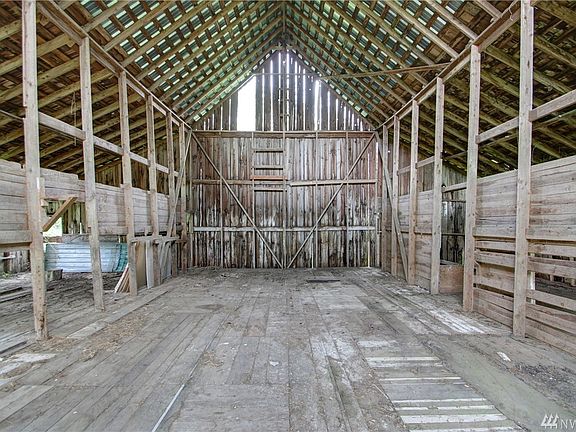 Old rustic barn has metal roof over midsection.  All sorts of uses--