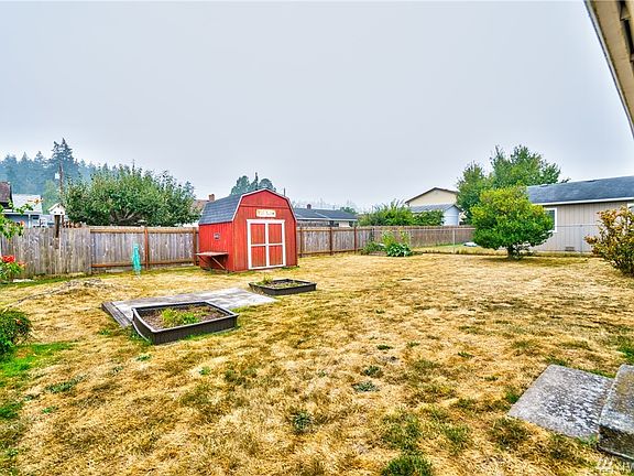 Cute level backyard that has raised beds, fully fenced and cute garden/storage shed. What a great outdoor living space for humans and pets!