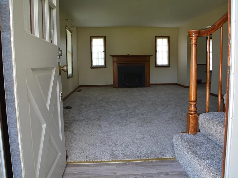 Family room with gas fireplace logs.