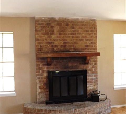 Cozy wood burning brick fireplace
