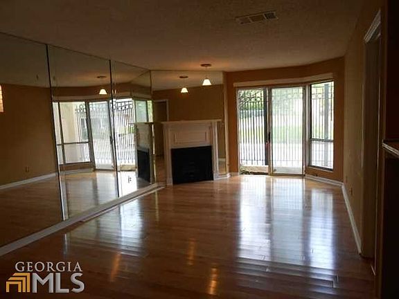 Large open living area with great hardwoods. Gas fireplace, exit to small private patio.