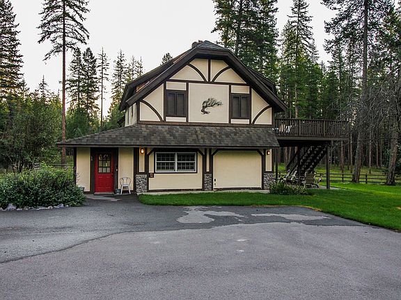 View of home from driveway. The main living area with expansive deck, kitchen, family room and primary bedroom is located on the second floor. 

The first floor offers a second kitchen, a family game room, a nice laundry room and two bedrooms.