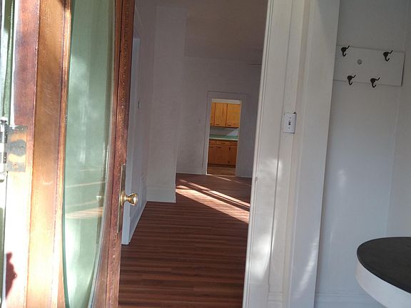 View of house interior (foyer, living room, dining room, and kitchen visible) from front entry door.