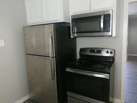 Stainless Appliances and Tall Overhead Cabinets