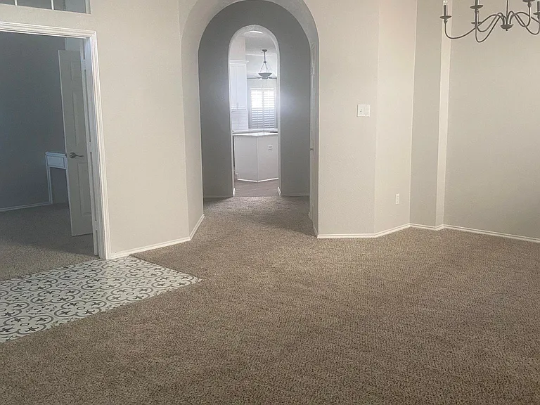 An arched entryway connects the formals to casual living.