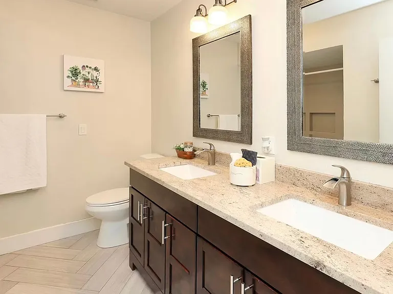 Upstairs bathroom with double sinks and bathtub