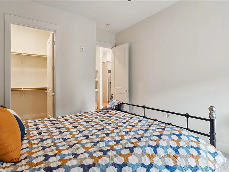Primary bedroom with walk in closet and 10 foot ceilngs