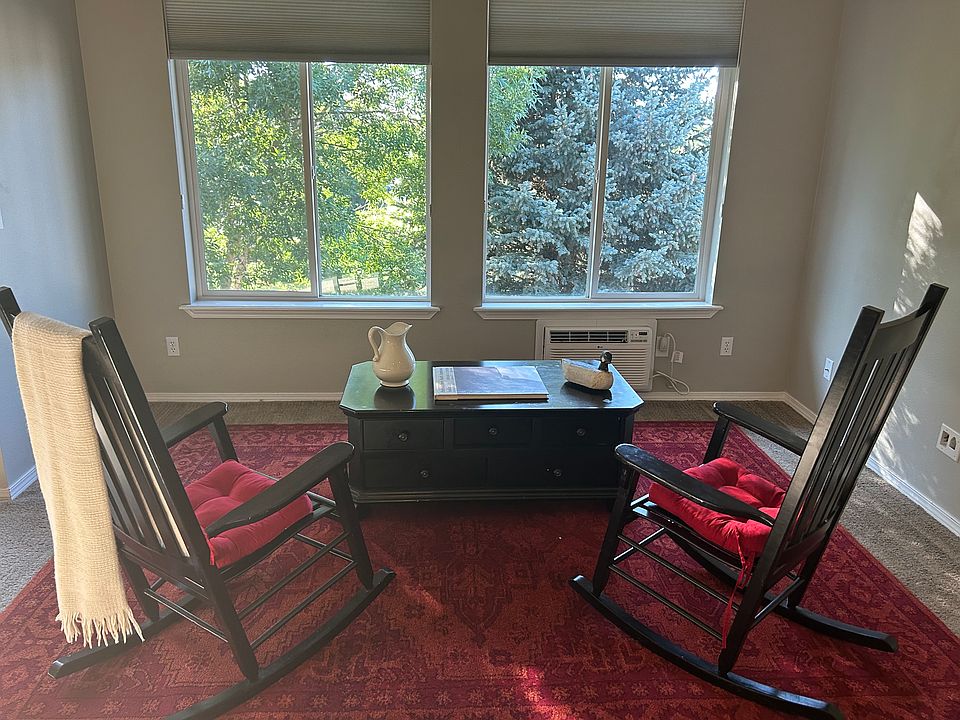 Spacious living room with view of green space