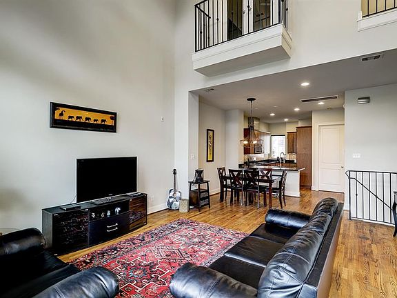The living area is open to the dining room and kitchen.