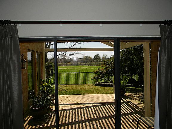 View from the living room out to the deck & all that acreage beyond.