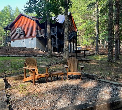 back area ... this is where we use our removable fire pit. We have 2 adirondack chairs and additional folding chairs you can bring out found in our basement. Our basement is for storage only.