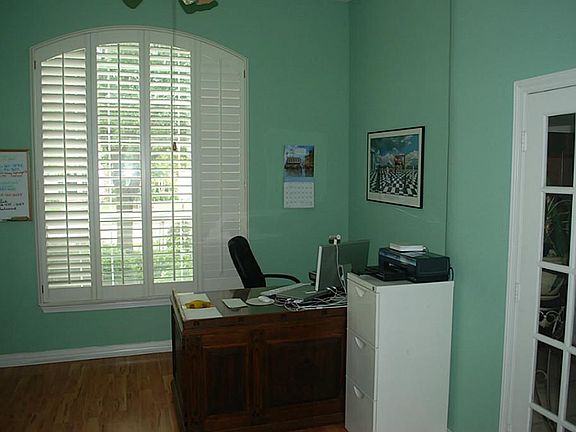 Another view of the study showing the plantation shutters and french doors.