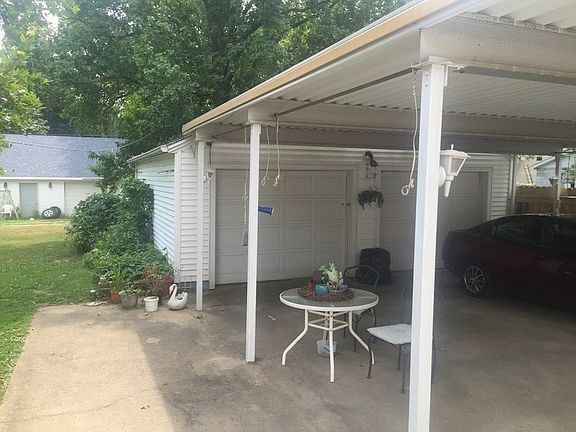 Back patio, carport, and garage
